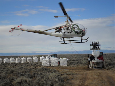 Helicopters distribute pelleted urea to fertilize sagebrush on the margins of the Pinedale Anticline Project Area in western Wyoming. Photo courtesy Dan Stroud.