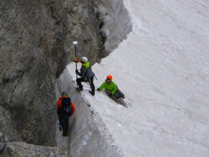 G. R. Fletcher (with pole) and Molly Tyson (belaying), both Jenny Lake Rangers, with Je Orlowski, CSU graduate student, surveying the top of Schoolroom Glacier in 2014.