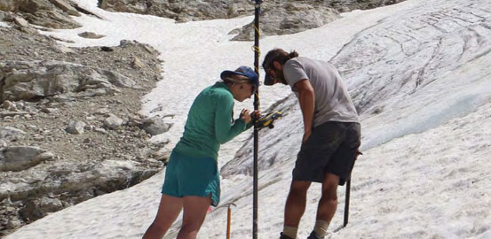 Emily Baker and James Kardouni, seasonal glacier monitoring sta for Grand Teton National Park, surveying reference points on Middle Teton Glacier.