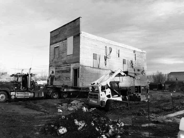 A building on a truck with construction in the foreground