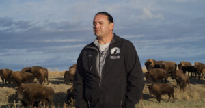 Jason Baldes in front of a herd of bison