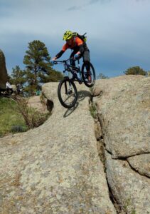 A mountain biker rides a boulder feature at Curt Gowdy State Park. (Courtesy Todd Thibodeau) 